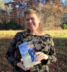 Arianna holding Hearken to Avalon 1